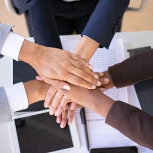 Business team showing unity with putting hands together. Businesspeople joining hands together. Stack of hands concept