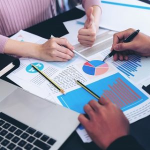 close up hand of  Business man busy at office desk  on  Notebook and documents  working  , business concept